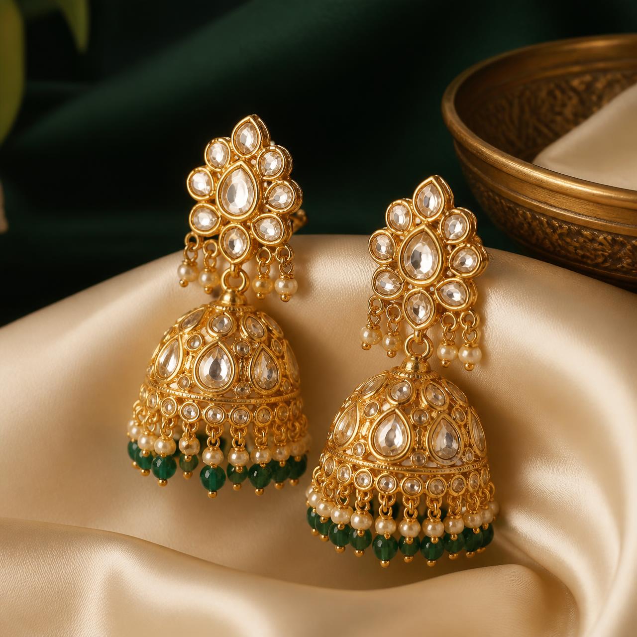 Handcrafted gold kundan jhumka earrings styled for a Karigra storefront